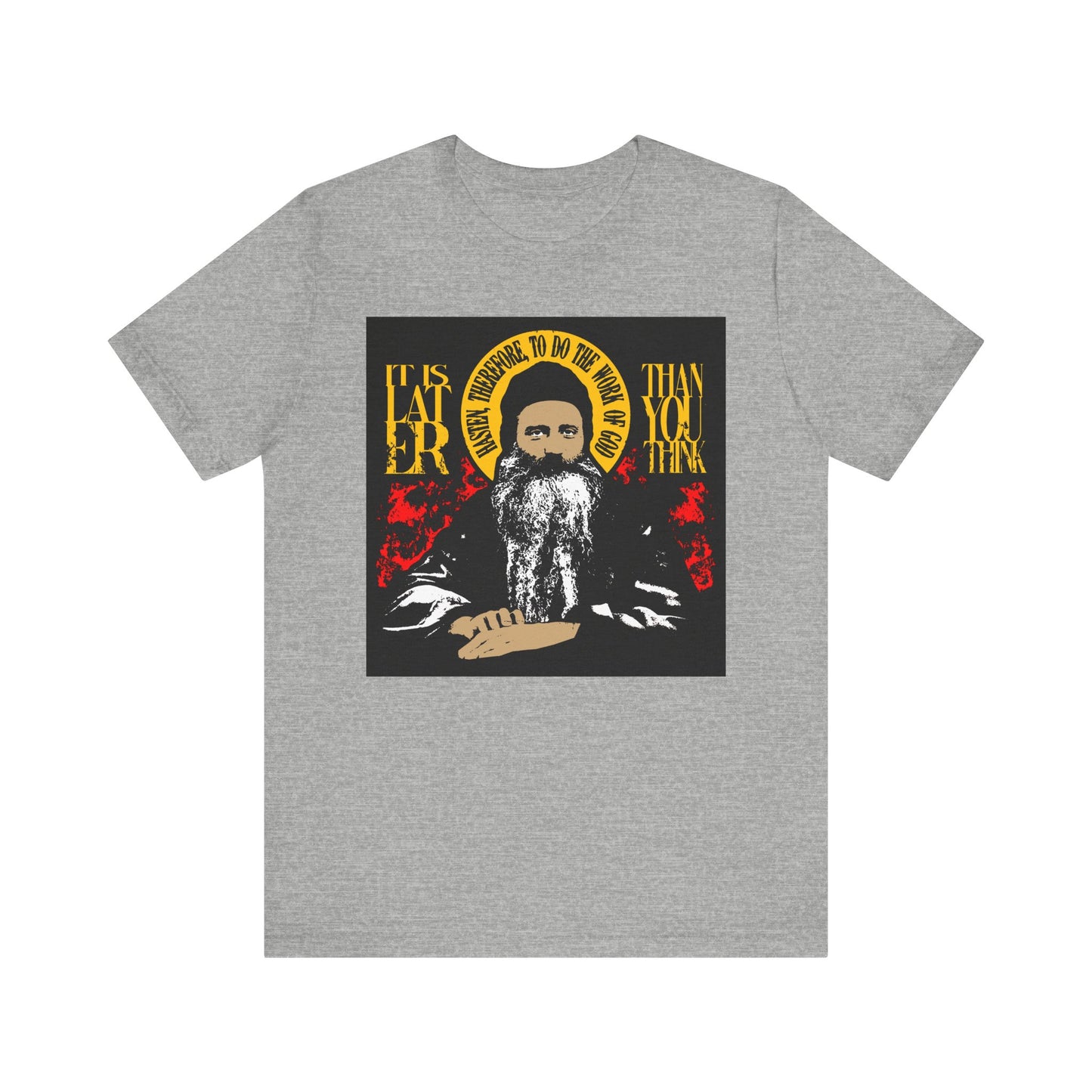 Athletic Heather t-shirt featuring a striking red and yellow design with an illustrated bearded figure, a yellow halo, and bold yellow text reading “It is later than you think.” Inspired by Orthodox spiritual literature—specifically Fr. Seraphim Rose—this lightweight cotton unisex tee serves as a thoughtful reminder of the importance of spiritual discipline.