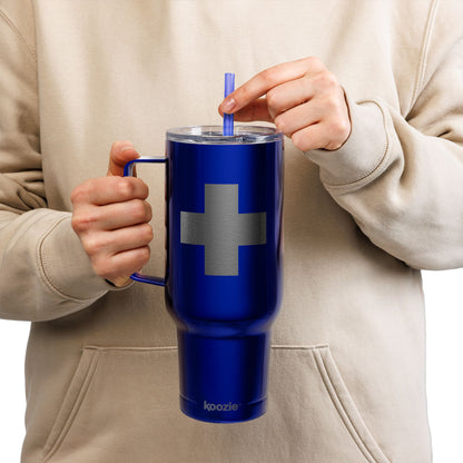 A person in a beige hoodie drinks from a straw in a blue Minimalist Cross Engraved 40oz Koozie Tumbler—an insulated stainless steel accessory that reflects the reverence Orthodox Christians have for the Exaltation of the Cross, ideal for home or travel.
