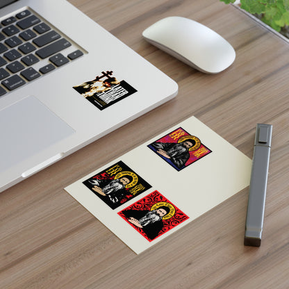 A laptop with the Fr Seraphim Rose Four Sticker Sheet No. 1, a mouse, and a card on a wooden desk.