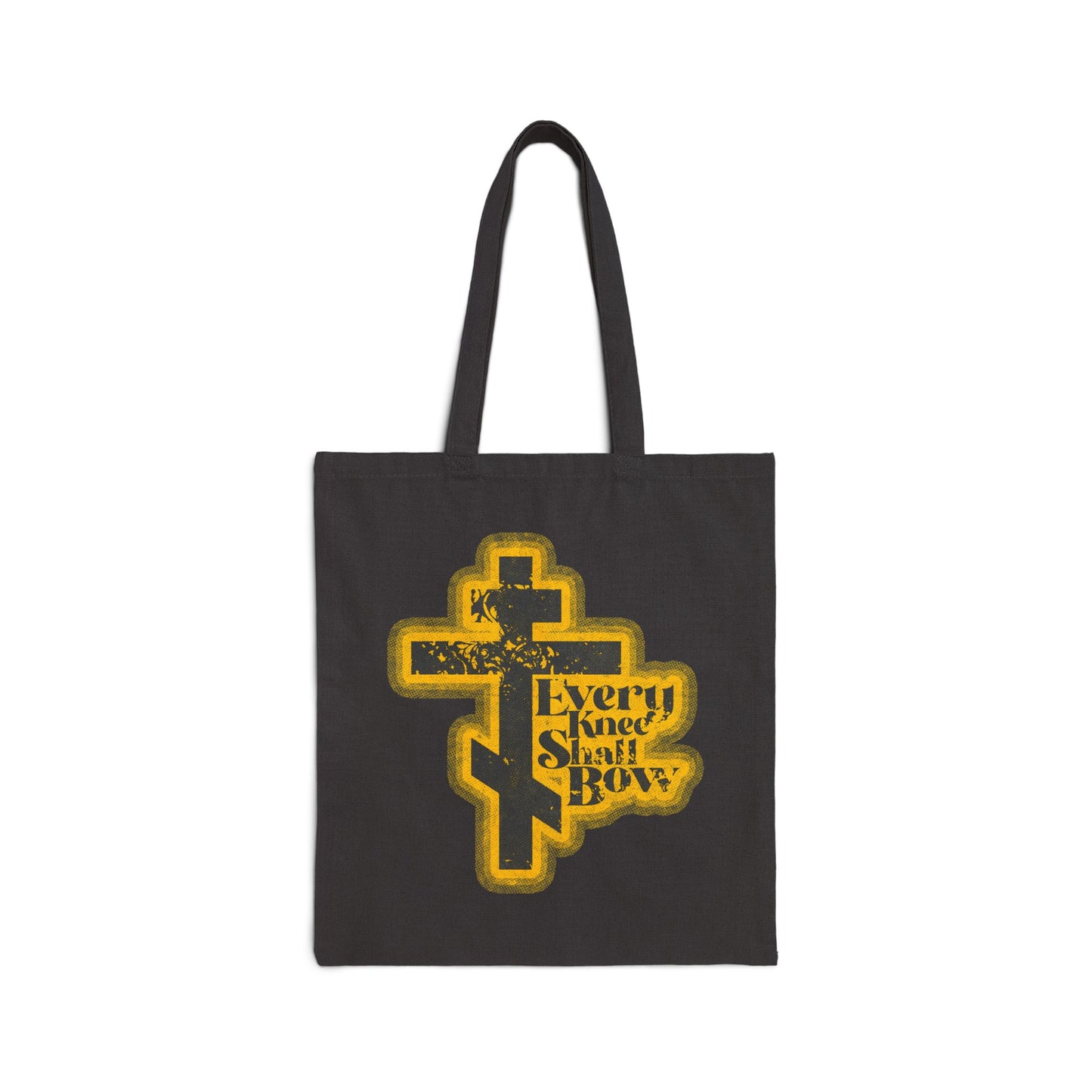 Black tote bag with a yellow cross and bold, distressed text: "Every Knee Shall Bow." 70s halftone comic book style. Inspired by Philippians 2:10-11, Isaiah 45:23. Orthodox Christian themed.