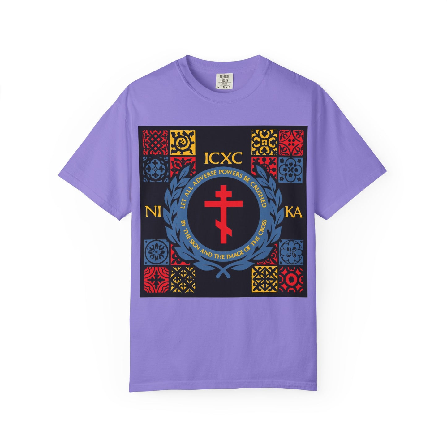 Violet heavyweight cotton unisex t-shirt titled "Let All Adverse Powers Be Crushed," featuring a bold red cross, ICXC NIKA Greek letters inspired by Katavasia, and vibrant red, yellow, and blue geometric patterns in a medieval tile design on the front.