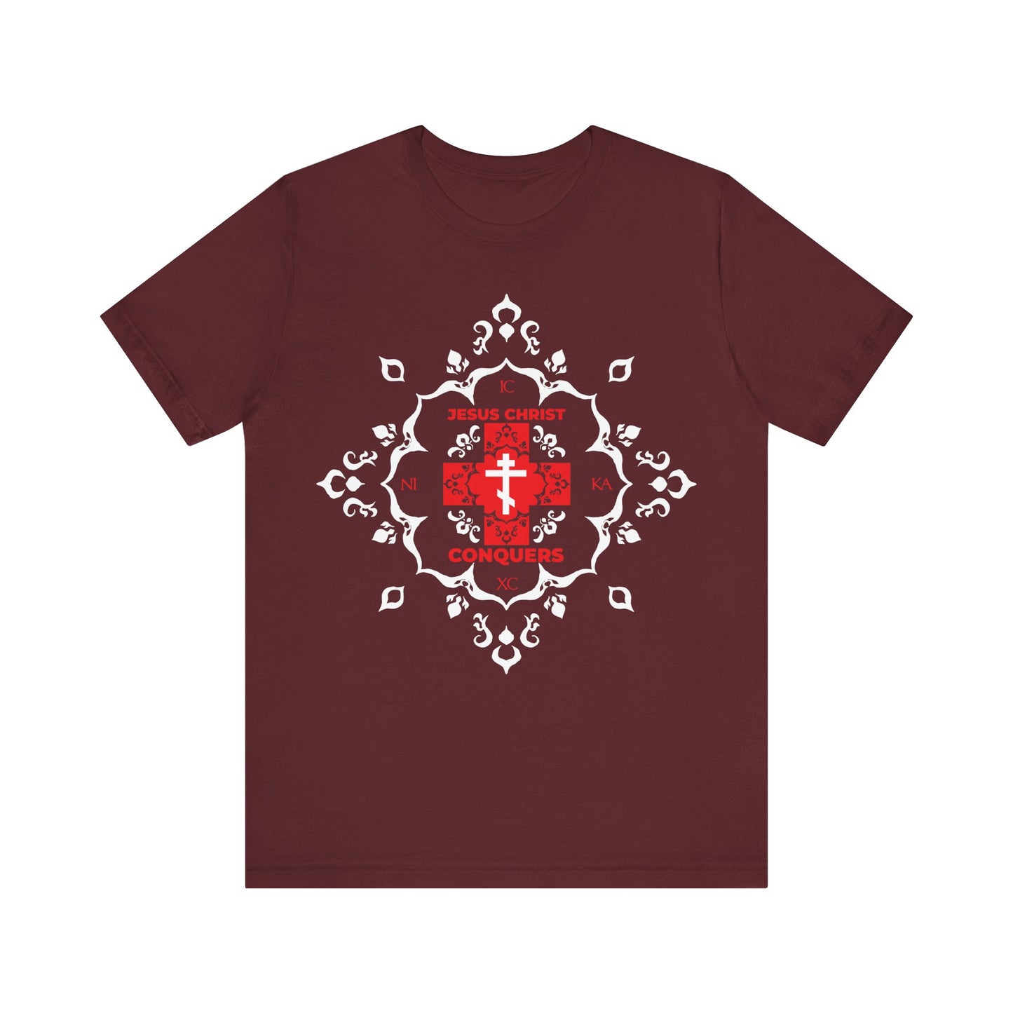 Maroon cotton t-shirt featuring a white Orthodox cross with red modern font reading "ICXC NIKA Means Jesus Christ Conquers" and medieval filigree design, inspired by Christian tradition.