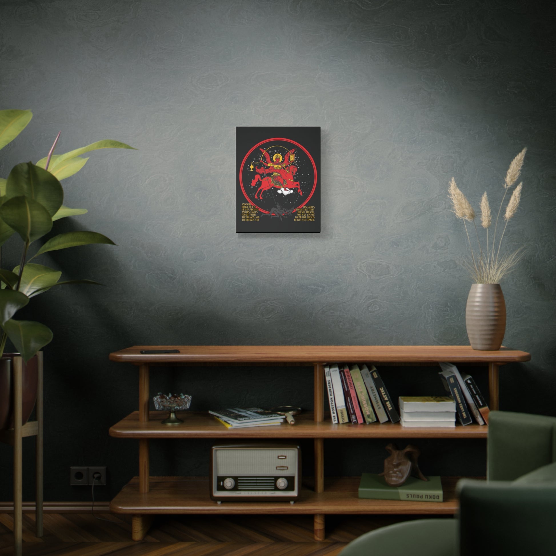 The "Archangel Michael of the Apocalypse Icono-Graphic" Christian canvas art (War in Heaven, Rev 12:7-9) hangs above a mid-century console with books, plants, and a vintage radio in a cozy room.