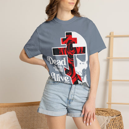 Woman wears the "Dead to this World" bestselling heavyweight cotton unisex tee, featuring a goth flower cross with skull and 70s typography—symbolizing Christian renunciation of the world.