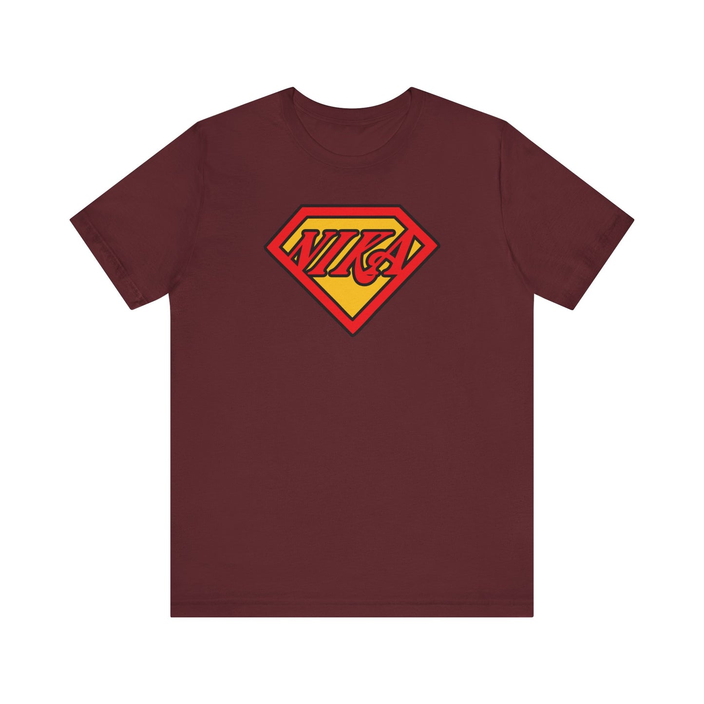 Maroon NIKA Superm@n Logo Tee featuring a yellow and red Superman-style diamond emblem on the chest—a pop culture-inspired Christian mashup that boldly celebrates faith, inspired by St John of Kronstadt’s call to conquer passions.