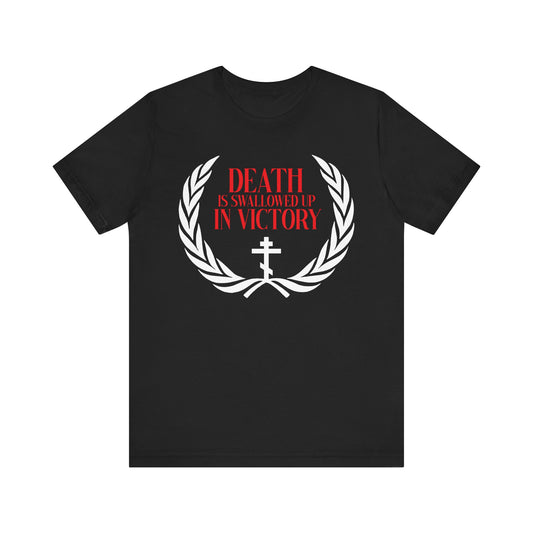 Black lightweight cotton t-shirt featuring an Orthodox cross, victory wreath, and “Death is Swallowed Up In Victory” (1 Cor 15:54) in red and white—a bold Christian symbol of triumph over death.