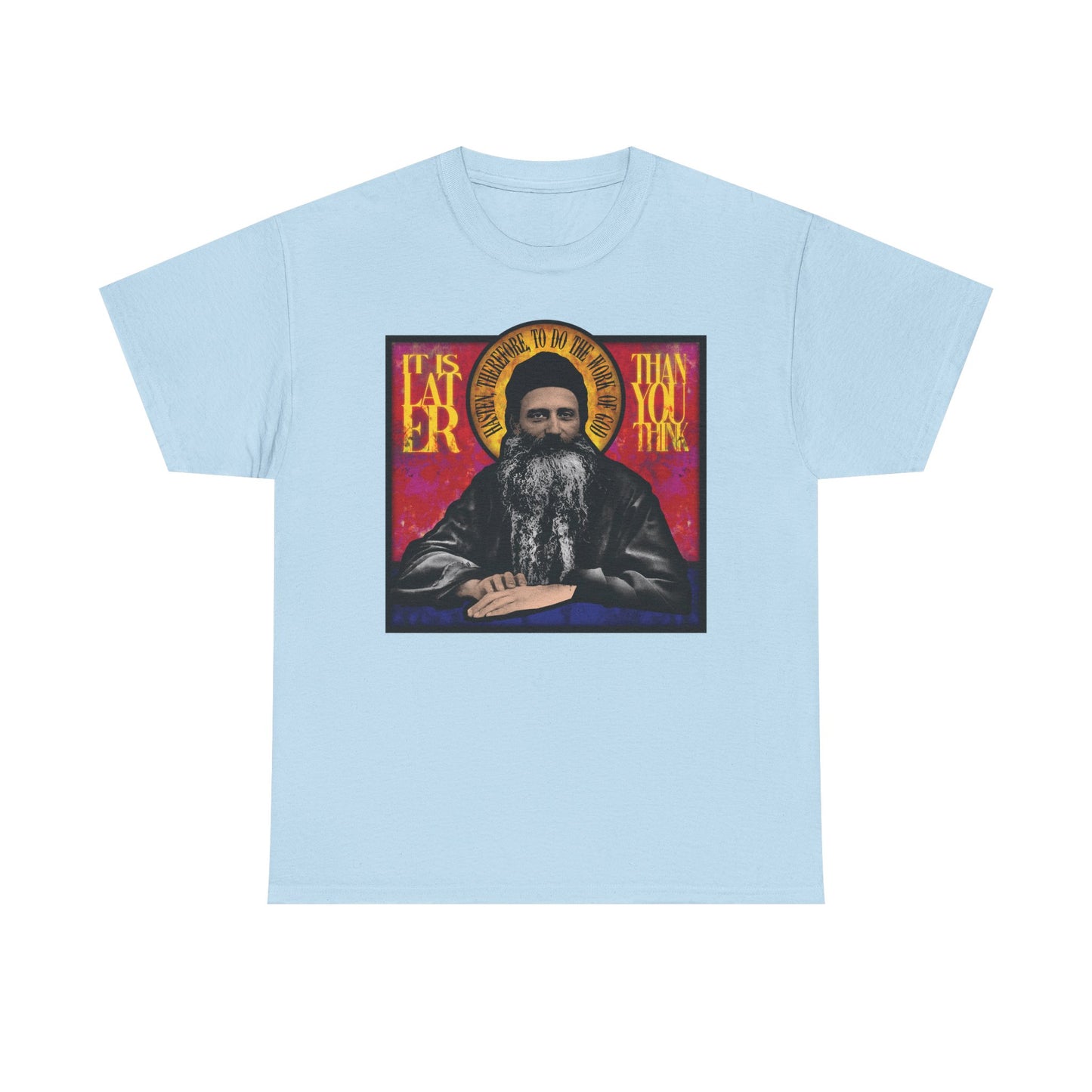 Light blue "It Is Later Than You Think" t-shirt, featuring a stained glass design of Fr. Seraphim Rose and thought-provoking text that evokes reflection on salvation and the Kingdom of Heaven; crafted from midweight cotton in a unisex fit.