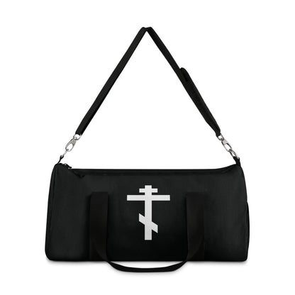 Black gym duffel bag with double handles, featuring a white Orthodox cross and Galatians 6:14—"May I never boast, except in the cross of our Lord Jesus Christ." A nod to Orthodox Christian faith.