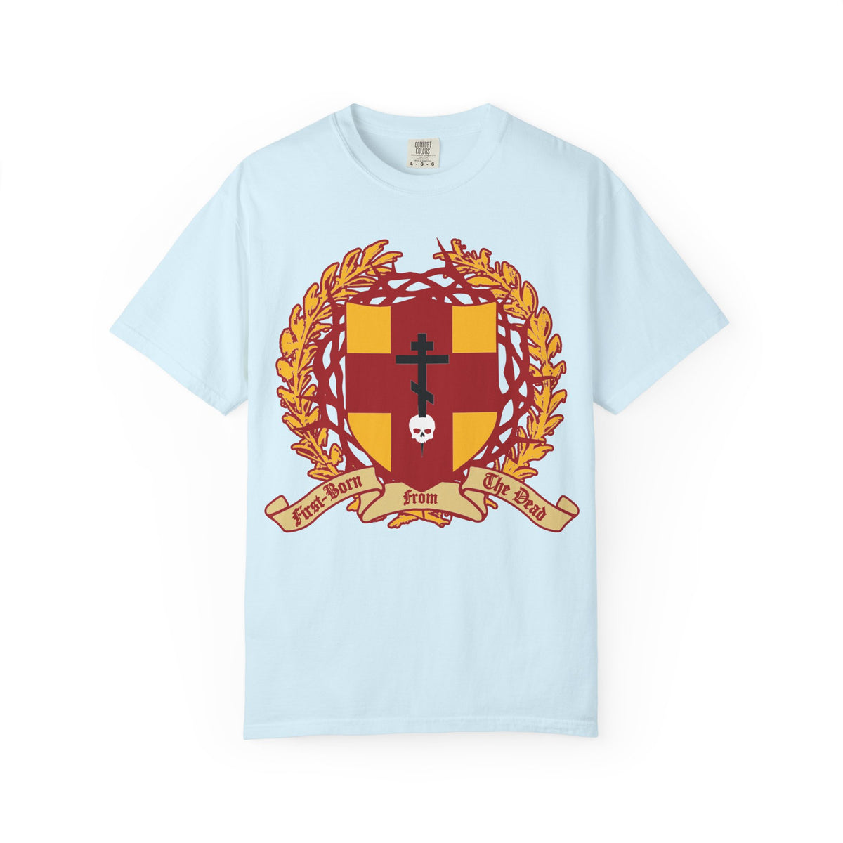 Chambray heavyweight cotton unisex T-shirt featuring a heraldic shield with a red and gold Orthodox cross stabbing a skull, crowned with thorns and adorned with the banner “First-Born from the Dead” (Col 1:18)—a striking design inspired by redemption through His blood.