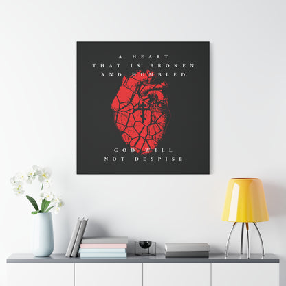 The "A Heart That is Broken and Humbled God Will Not Despise" canvas art, showing a cracked heart with an Orthodox cross, hangs above a shelf with decor, expressing repentance and inspired by Psalm 51.