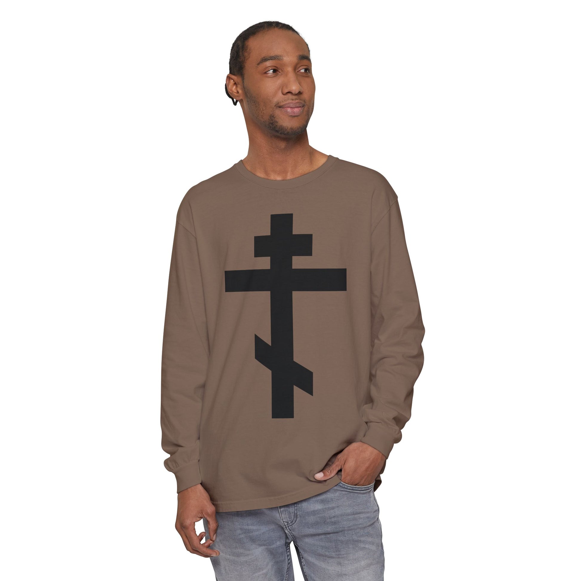 Man wearing a brown Orthodox Long Sleeve Shirt with a large black cross and the quote, "May I never boast, except in the cross of our Lord Jesus Christ" (Gal 6:14), inspired by the Black Orthodox Cross design.