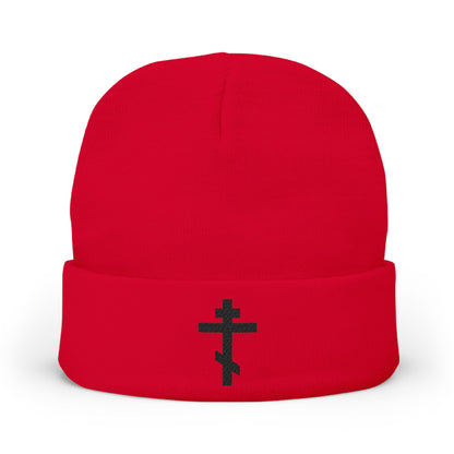 Red beanie featuring a black Orthodox TriBar Cross and the phrase "Nail My Passions to the Wood of Thy Precious Cross O Lord" embroidered on the folded brim, displayed on a white background.