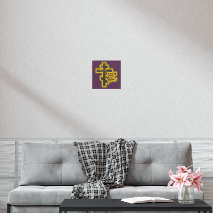 A cozy living room with a grey couch, plaid throw, coffee table, flowers, and the "Every Knee Shall Bow" 70s distressed comic-style Orthodox Christian art poster (Philippians 2:10-11) displayed above the sofa.