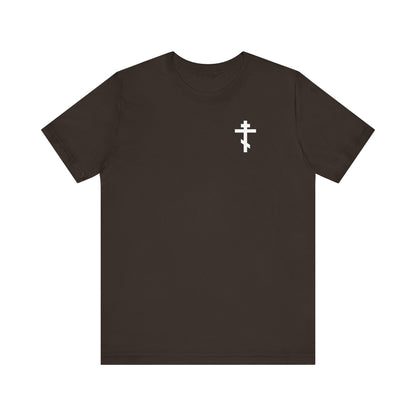 Brown tee featuring a small white cross on the left chest and a skull-and-cross-back design with a red rose; goth aesthetic, lightweight cotton, unisex fit.