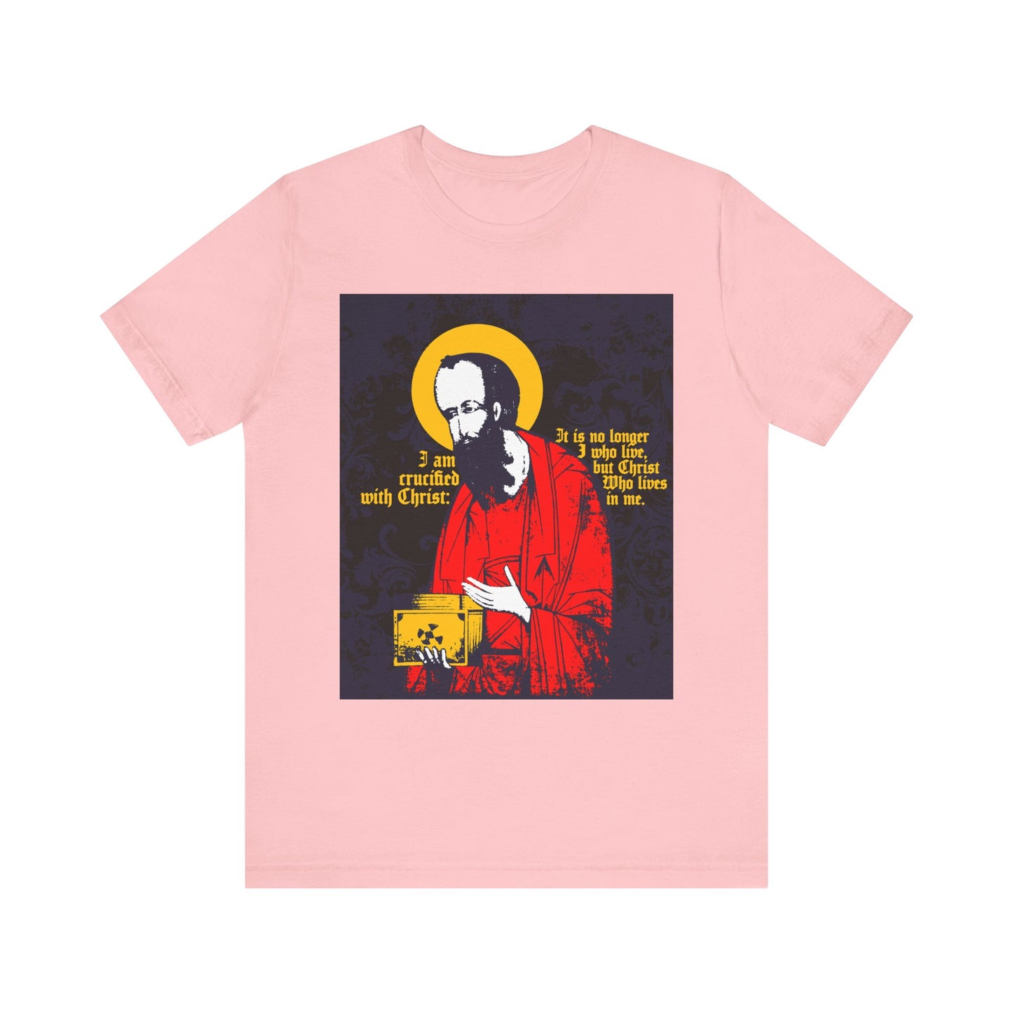Pink "St Paul Holding Gospel Iconographic" lightweight cotton unisex tee, featuring a stylized image of St. Paul with a yellow halo and the Bible verse "I am crucified with Christ (Galatians 2:20)" in white and yellow, celebrating new life in Christ.