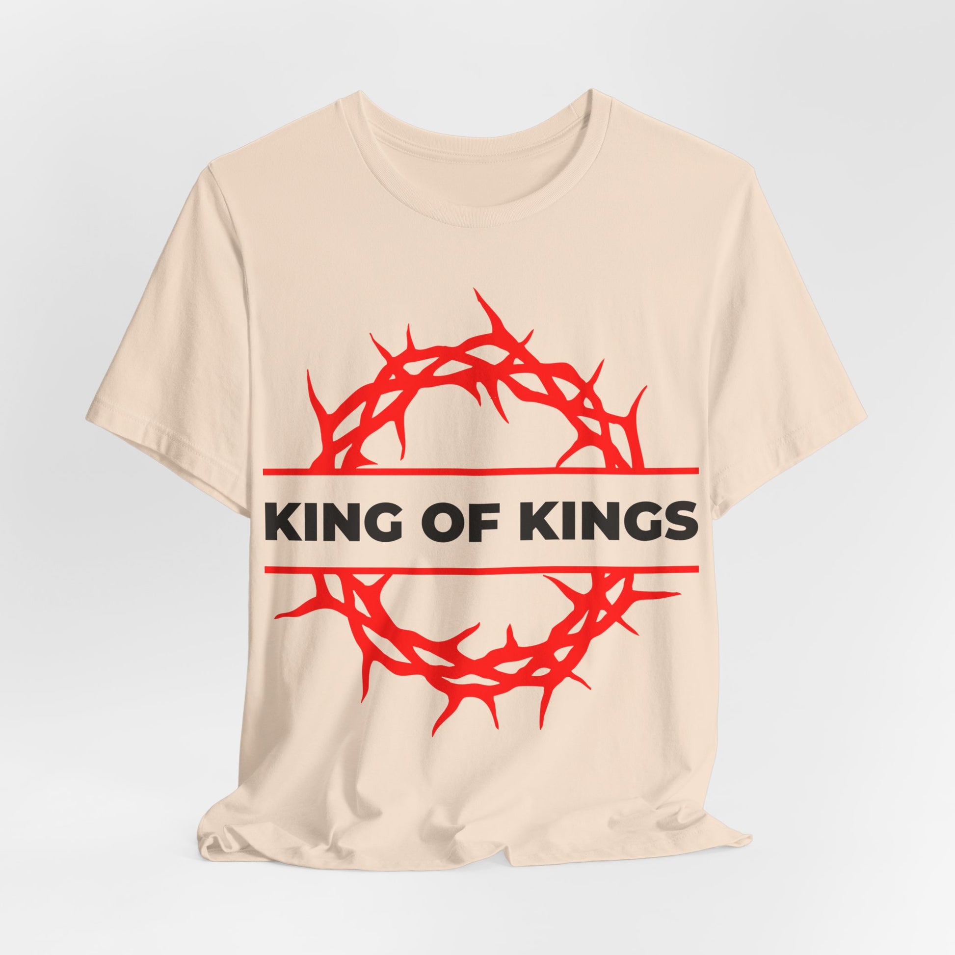 The King of Kings Crown of Thorns unisex beige cotton tee features a red crown of thorns and bold KING OF KINGS text, inspired by Revelation 19:16. Orthodox Christian design – Christ is King, The King of Glory.
