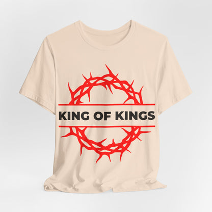The King of Kings Crown of Thorns unisex beige cotton tee features a red crown of thorns and bold KING OF KINGS text, inspired by Revelation 19:16. Orthodox Christian design – Christ is King, The King of Glory.