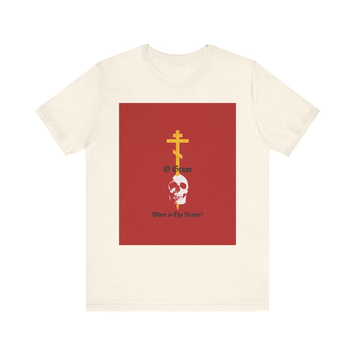 Natural cotton unisex tee featuring a gold Orthodox cross piercing a skull, accented with striking red and the text “O Grave, Where Is Thy Victory? 1 Cor 15:55”—a bold Christian reflection on resurrection and salvation.