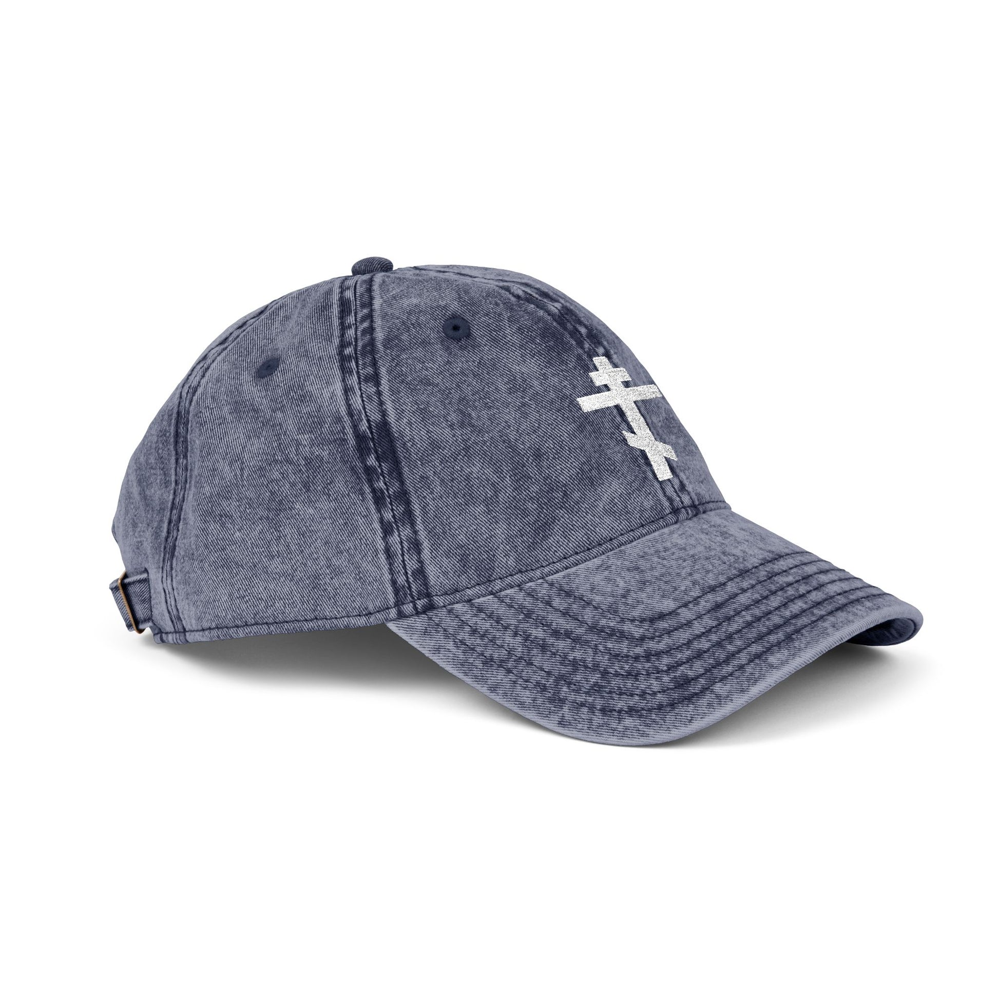 Minimalist blue denim cap with a white Orthodox TriBar Cross, symbolizing Christ’s crucifixion. Features "Crucify My Ego to the Precious and Life-Giving Cross" embroidered design. Distressed, simple Christian style.