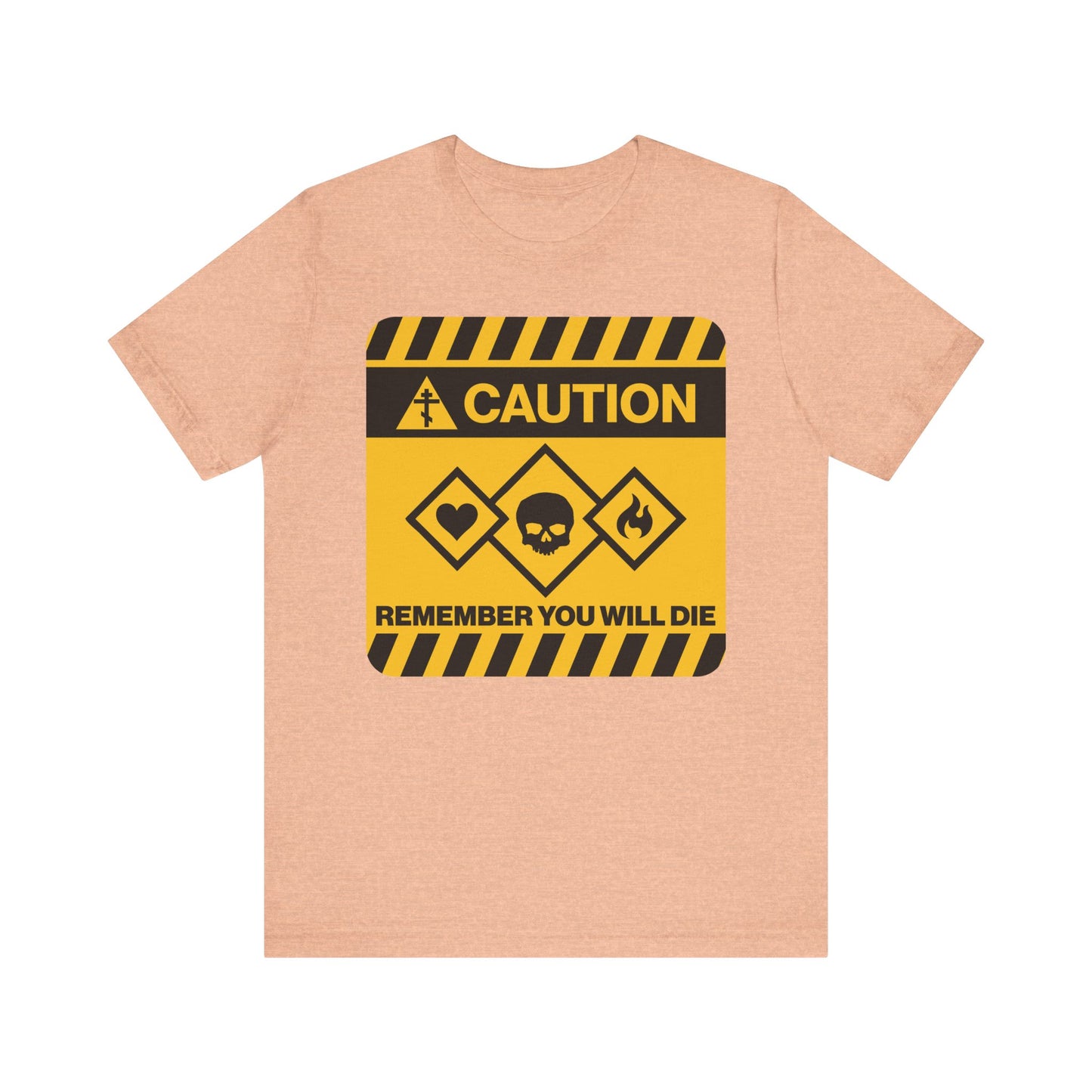 Heather peach unisex tee featuring a yellow caution street sign design with "Remember You Will Die" and hazard symbols—a memento mori inspired by Orthodox Christian tradition, echoing the wisdom of St. Irenaeus of Lyons.