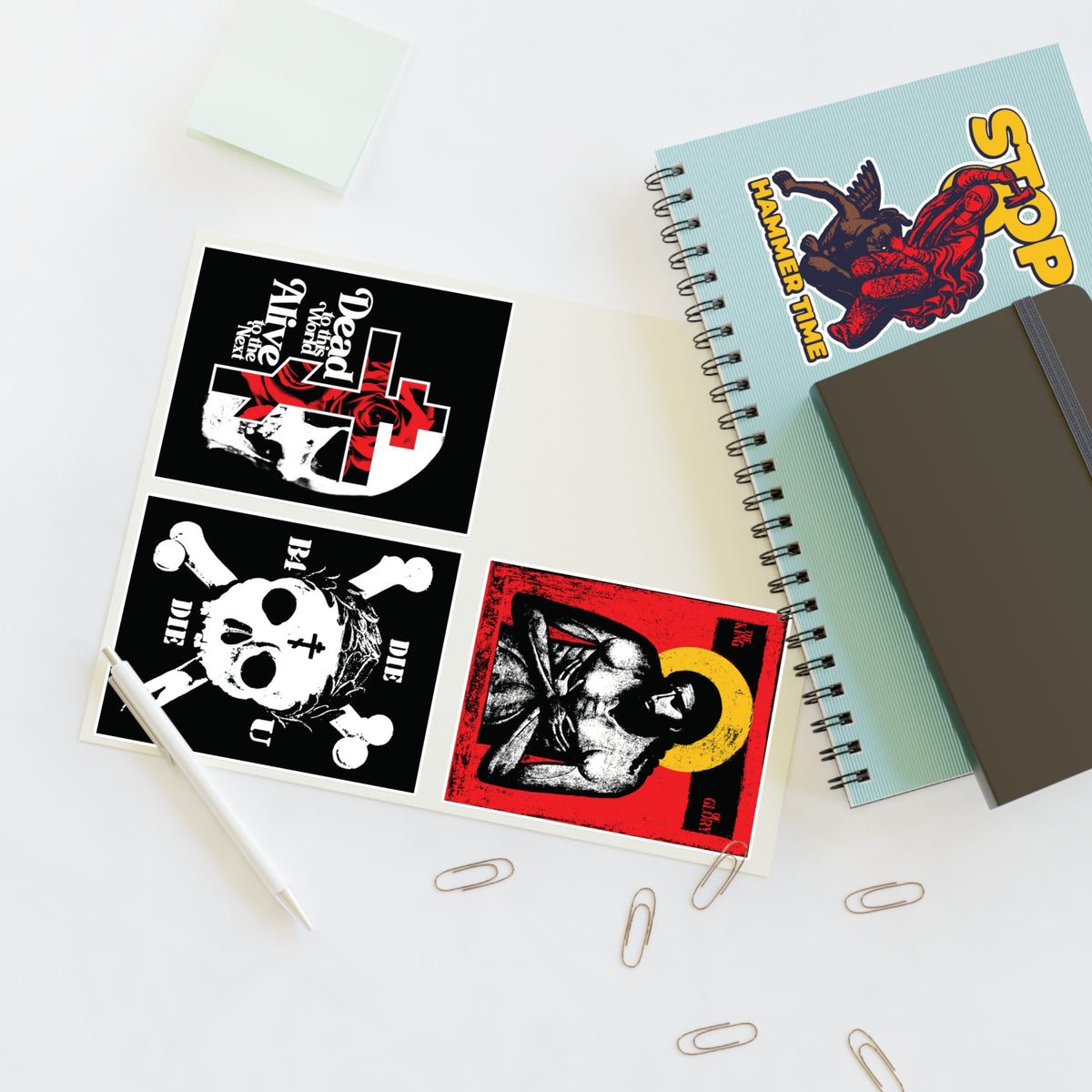Open notebook with Random Mix No. 1 Four Sticker Sheet | Jesus Christ Iconographic | Orthodox Stickers on desk.