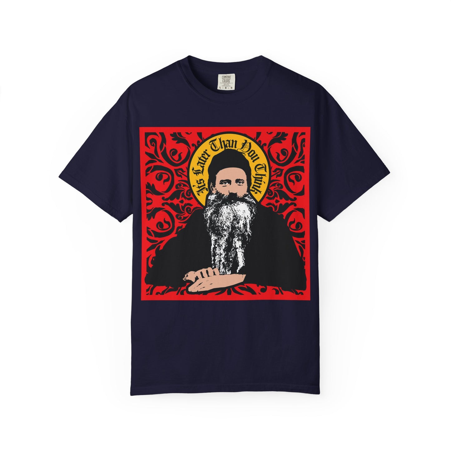 True Navy heavyweight cotton unisex tee featuring an icono-graphic style image of Saint Seraphim Rose of Platina, set against an ornate red design—a striking tribute to the enduring spirit of Orthodoxy. This "It's Later Than You Think" shirt combines reverence and bold graphic art.