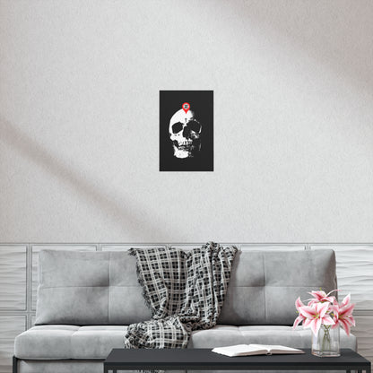 A "You Will Be Here Maps Marker on Skull" Orthodox Christian art poster, featuring the Memento Mori message, hangs above a gray sofa with a plaid throw, flowers, and an open book—echoing St. Ignatius Brianchaninov’s reflection on spiritual death.