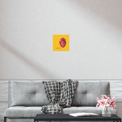 A gray sofa with a plaid blanket, pink flowers, and the "Remember You Will Die" Christian art poster featuring a retro medical heart and Orthodox cross creates a peaceful space—ideal for reflection and quiet moments.