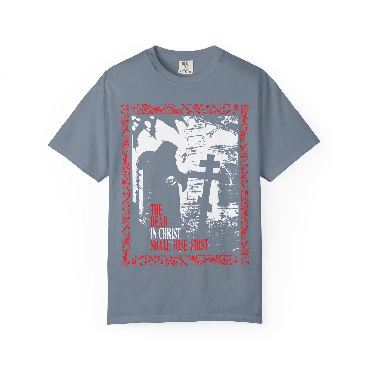 Blue Jean heavyweight cotton unisex tee featuring a gothic graveyard design with a hooded figure by a cross, and bold red text stating "The Dead in Christ Shall Rise First"—inspired by 1 Thessalonians 4:16 and symbolizing soul liberation and blessings after death; an Orthodox Christian statement piece.