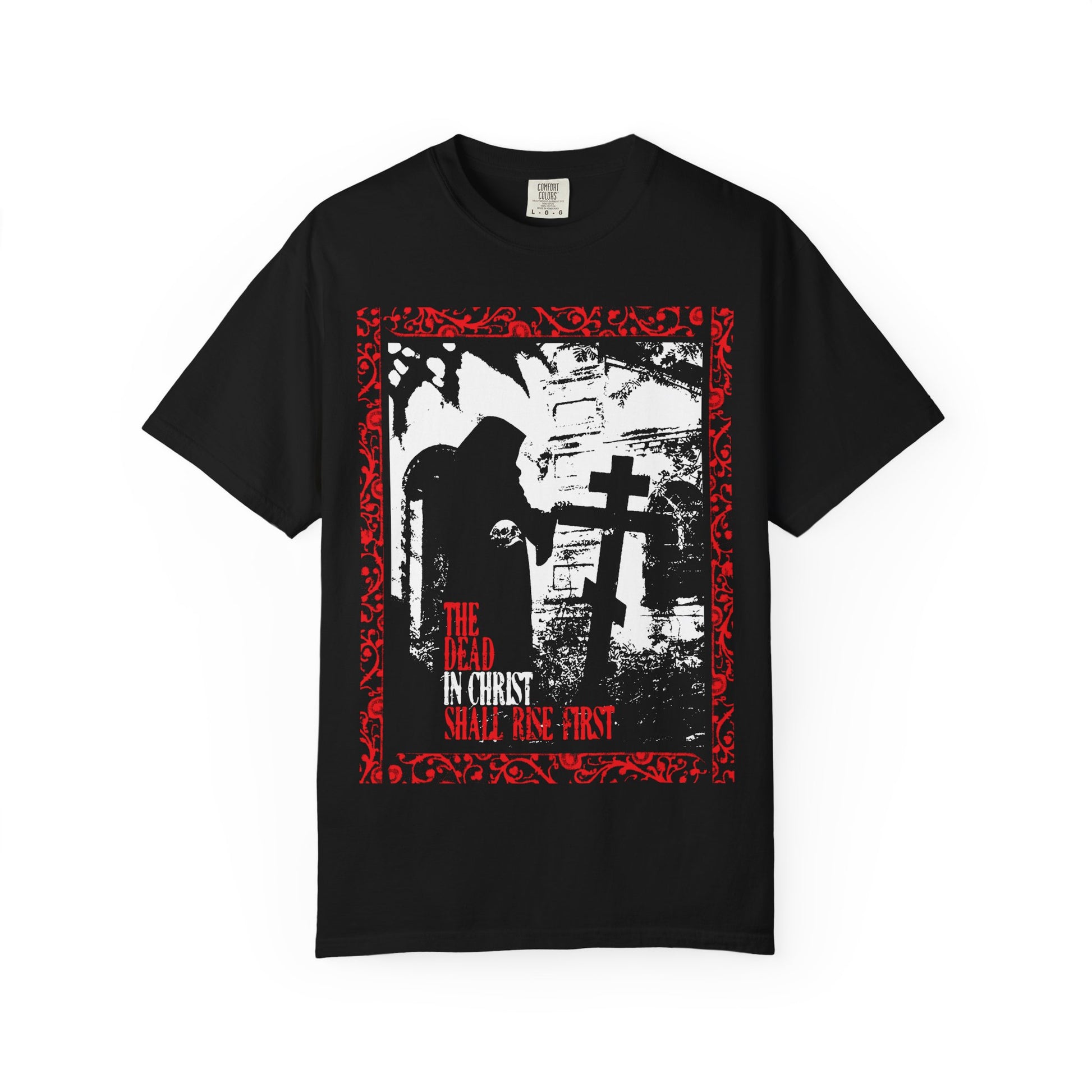 Black heavyweight cotton unisex tee featuring a gothic graveyard design with the Grim Reaper, cross, and vivid red border. Text: THE DEAD IN CHRIST SHALL RISE FIRST, inspired by 1 Thessalonians 4:16—a striking Orthodox Christian message of soul liberation and posthumous blessings.
