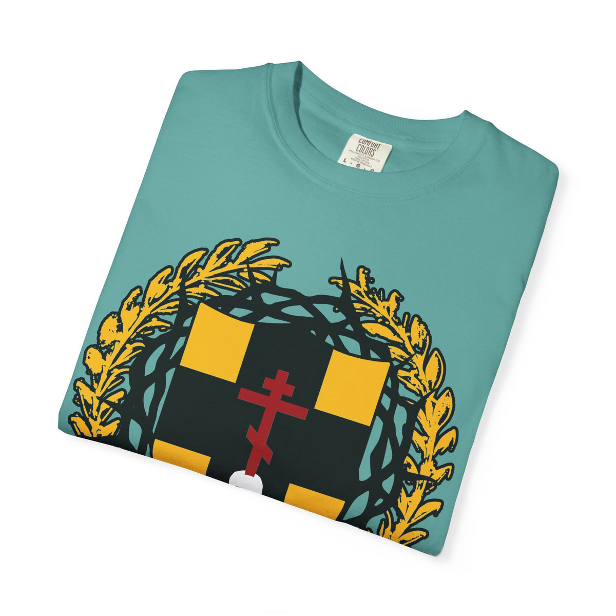 Wording rewritten using the product data: A folded teal “First-Born from the Dead (Col 1:18)” heavyweight cotton unisex t-shirt, featuring a heraldic yellow and black shield with a red Orthodox cross stabbing a skull, crowned with thorns and encircled by a golden wreath—the design symbolizes Christ’s redemption through His blood and recalls the protection of the firstborn in Egypt.