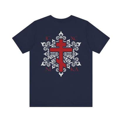 The ICXC NIKA Red Orthodox Cross BACK w/ Red Cross on Front Left Breast Lightweight Cotton Unisex T-Shirt features a navy color with an ornate red Orthodox cross, white medieval floral design, and the Greek letters IC XC NI KA; available as a custom order for a truly personalized touch.