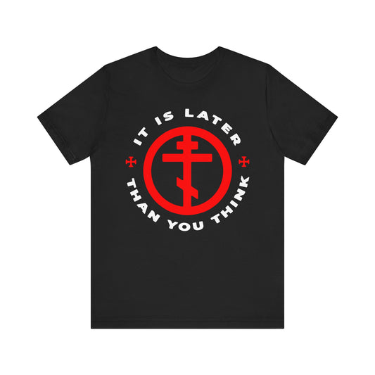 Black "It Is Later Than You Think" lightweight cotton unisex tee inspired by Fr Seraphim Rose and the call to put on the armour of light; features a red cross symbol and white text wrapping around the design, as a memento mori in the spirit of American Orthodox Christian tradition.