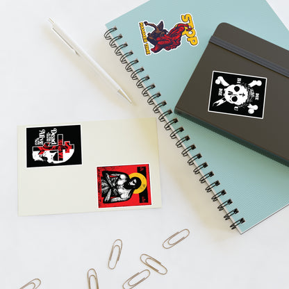 A notebook, notepad, pen, and paper clips on a white desk with Random Mix No. 1 Four Sticker Sheet stickers.