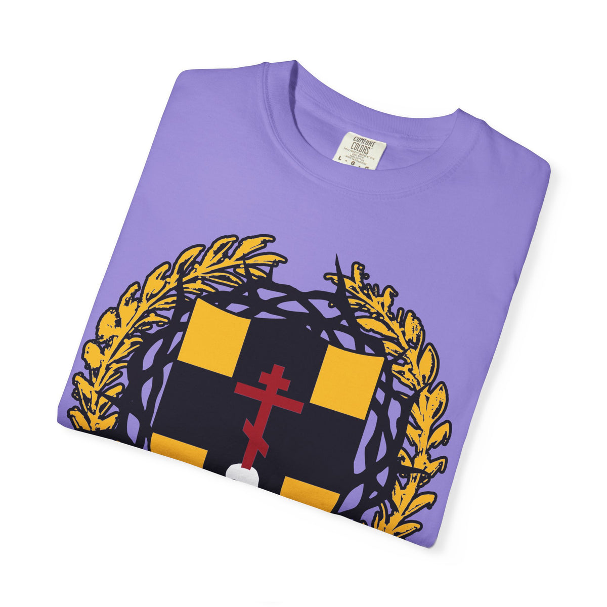 A heavyweight cotton unisex T-shirt, folded neatly in purple, featuring a gold and black heraldic shield with an Orthodox cross piercing a skull and adorned with a crown of thorns on the front— inspired by Colossians 1:18 and the theme of redemption through His blood.