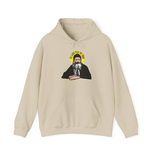 Sand-colored hoodie featuring a graphic of a bearded man with a yellow halo and the quote “It’s called fana which means...”. Inspired by the modern American Orthodox Christian saint Fr. Seraphim Rose, this “It’s Later Than You Think” hoodie evokes the presence of fearsome angels and contemplates themes of death.
