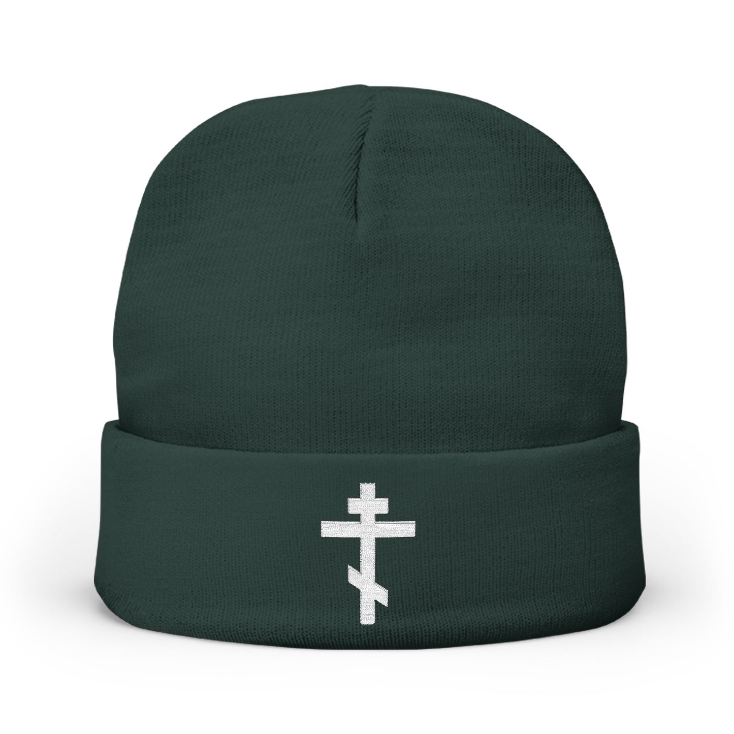 Dark green knit beanie featuring a white Orthodox TriBar cross and “Nail My Passions to the Wood of Thy Precious Cross O Lord” embroidered on the folded brim.