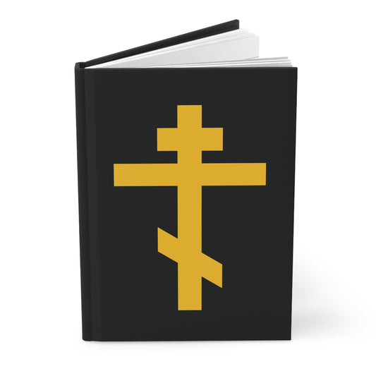 Black hardcover journal featuring a yellow Orthodox Cross on a black background, titled "Precious and Life-Giving Weapon of Unseen Warfare | Scourge of Demons | Orthodox Hardcover Journal." Inspired by Galatians 2:20.
