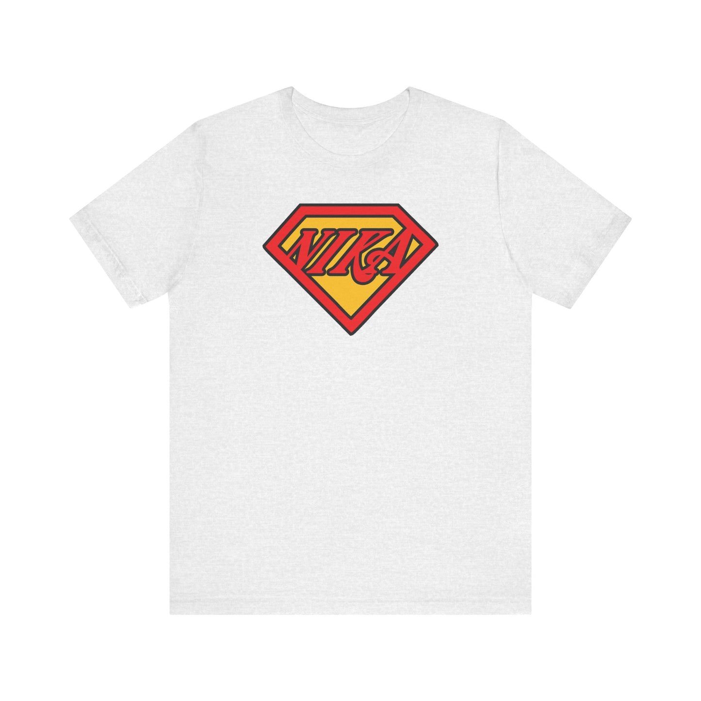Ash-colored T-shirt featuring the NIKA Superm@n logo—a comic book-inspired, pop culture Christian mashup in a Superman-style shield with the word "Nika" in stylized text. This lightweight cotton unisex tee pays homage to St John of Kronstadt's message, motivating you to conquer passions every day.