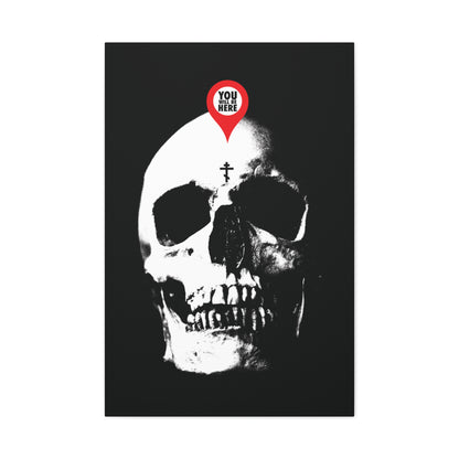 The "You Will Be Here Maps Marker on Skull" Orthodox Christian canvas art features a skull with a map pin reading "YOU ARE HERE," reminding viewers of memento mori and spiritual reflection, as inspired by St. Ignatius Brianchaninov.