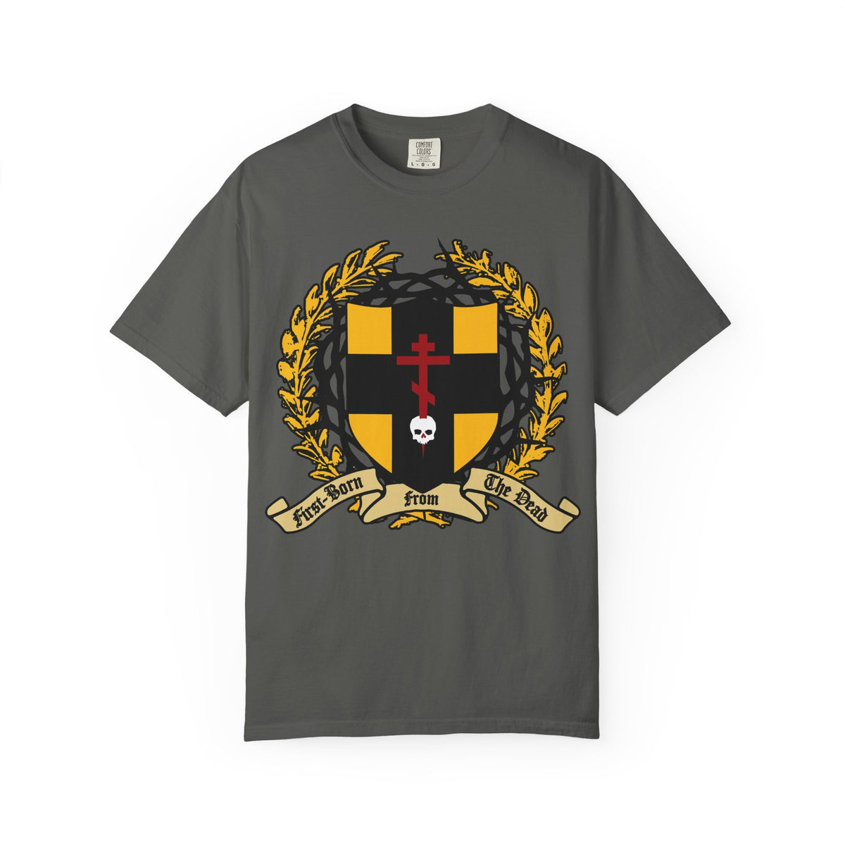 Pepper-colored heavyweight cotton unisex t-shirt featuring a heraldic shield with a black and gold crest, laurel wreath, skull pierced by an Orthodox cross, crowned with thorns, and a banner reading “First-Born from the Dead”—a bold design inspired by Colossians 1:18 and themes of redemption through His blood.