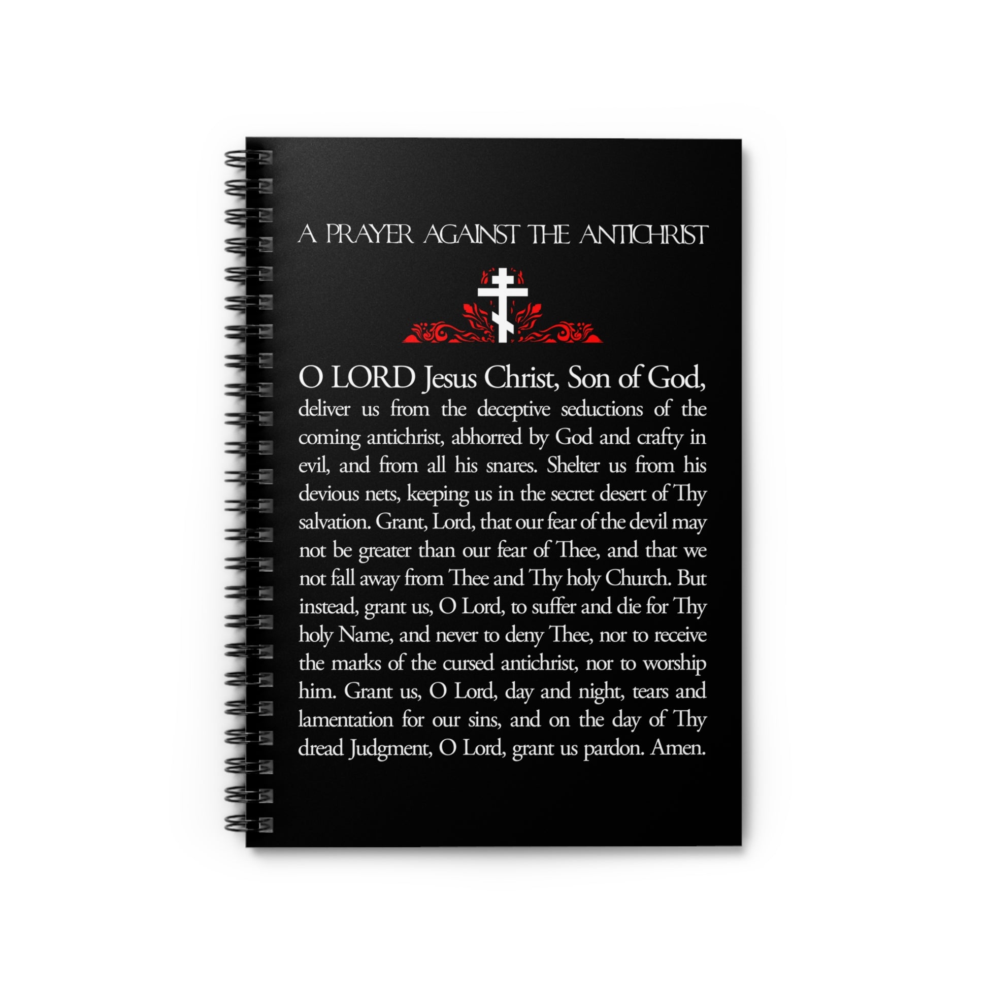 A black spiral notebook titled "Prayer Against the Antichrist By Elder Anatoly the Younger of Optina | Christ is King | Book of Revelation," featuring a Christian prayer and Orthodox design.