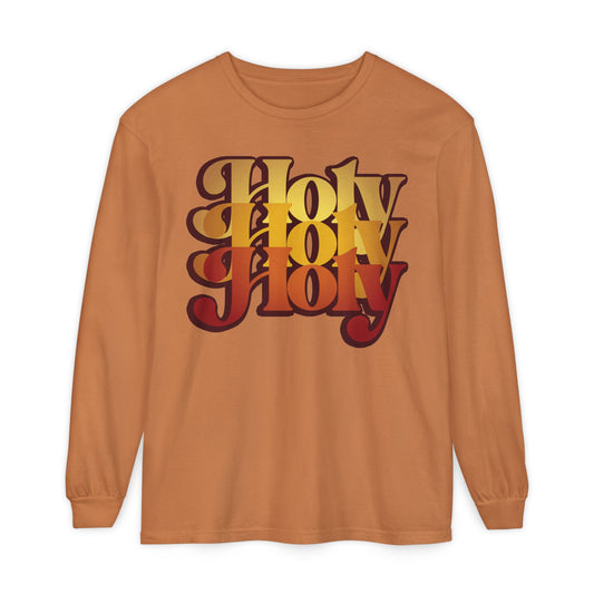 Yam-colored long sleeve cotton shirt featuring bold “Holy Holy Holy” text in a 70s retro gradient, inspired by the liturgical Trisagion prayer from Isaiah 6 and traditional Orthodox praise.
