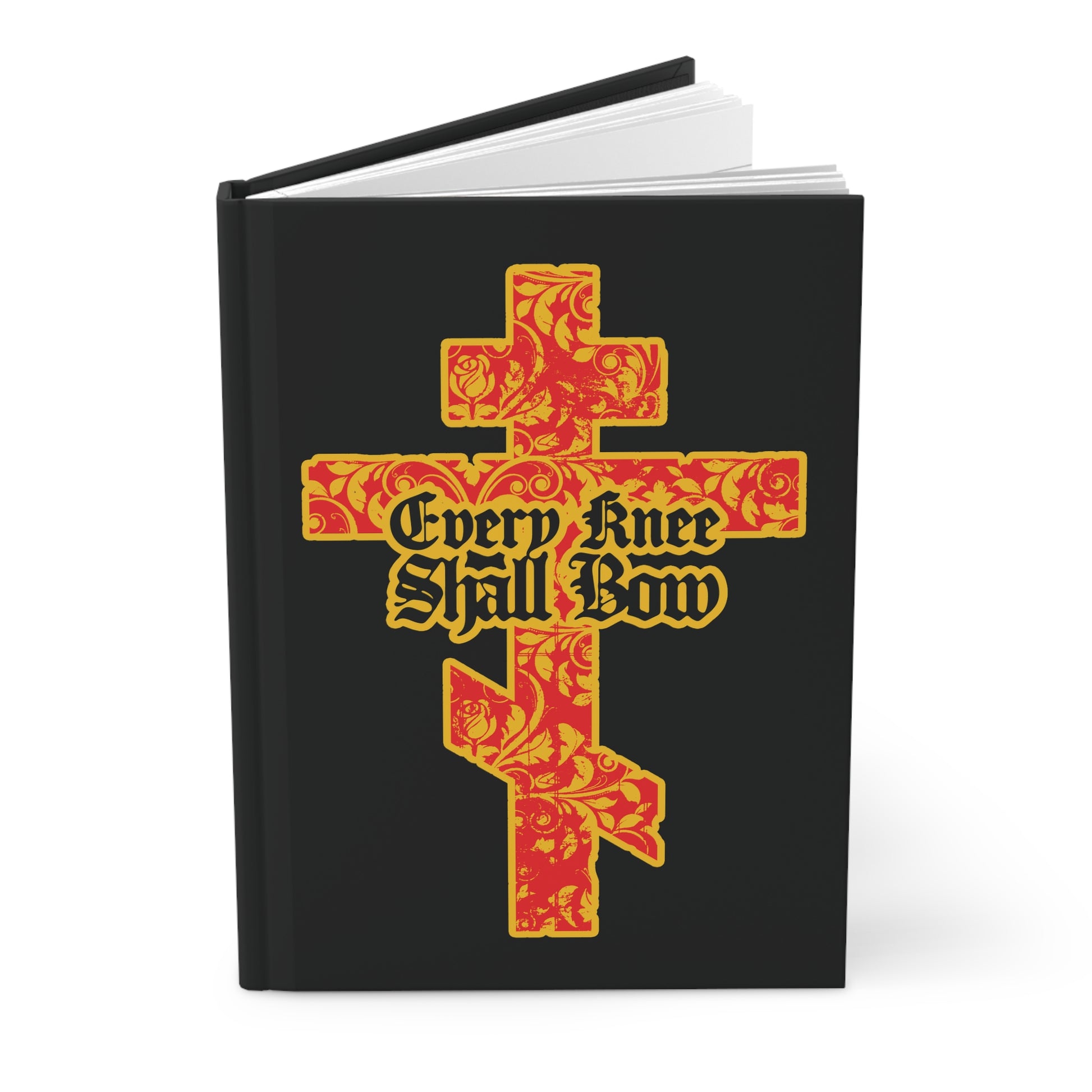 A black Christian journal titled "Every Knee Shall Bow" (Isaiah 45:22-24, Phil 2:7-11) features a gold and red floral Orthodox cross with gothic lettering on the cover.