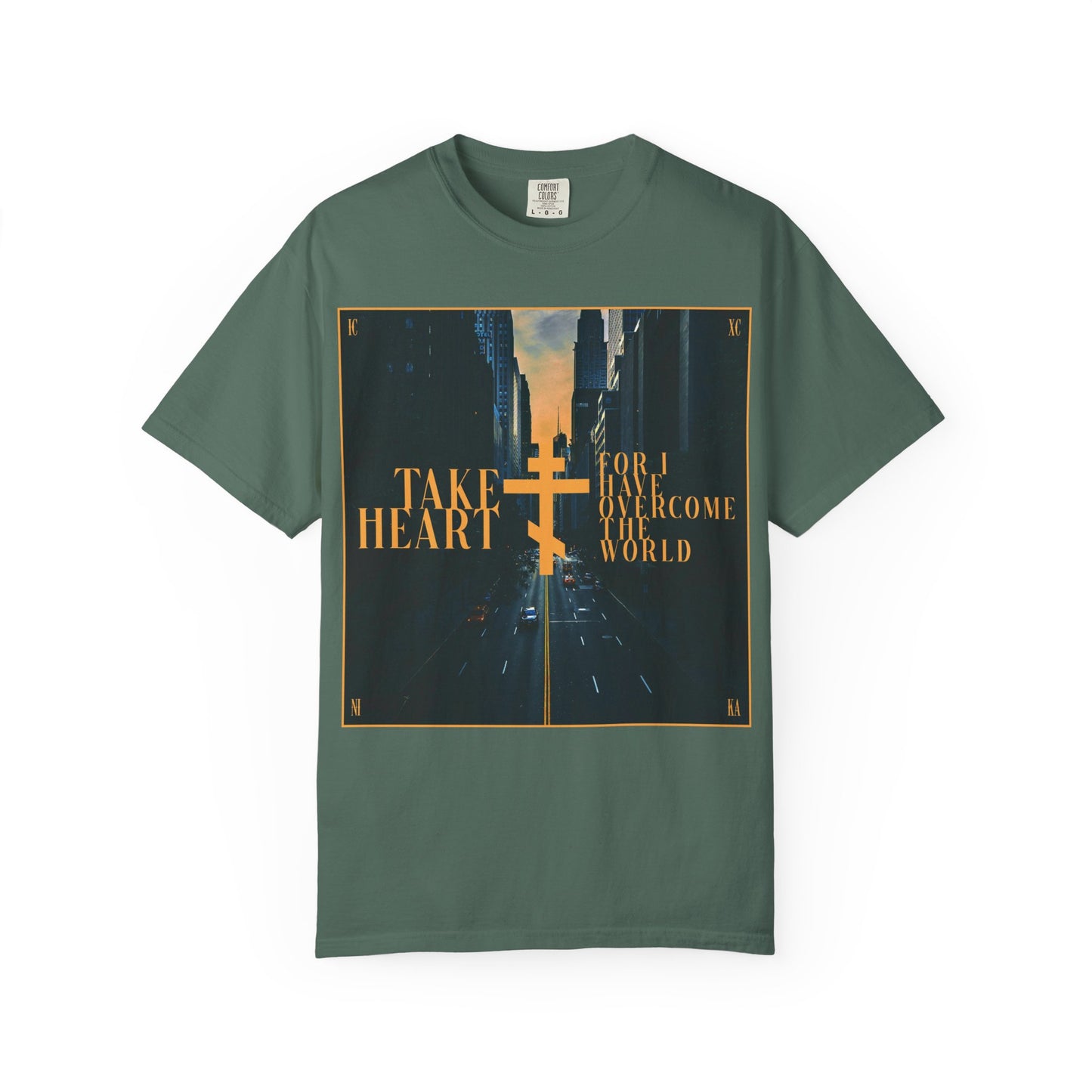 Blue Spruce heavyweight cotton unisex tee featuring a redemptive modern city street scene, gold cross, and the inspirational message: “Take Heart, for I have overcome the world” (John 16:33)—a reminder that sorrow can be transformed into joy when you ask and receive.