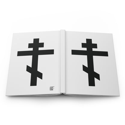 Open journal showing two bold black Orthodox crosses on white pages, inspired by the "Black Orthodox Cross White Background" Hardcover Journal featuring Galatians 6:14: "May I never boast, except in the cross of our Lord Jesus Christ.