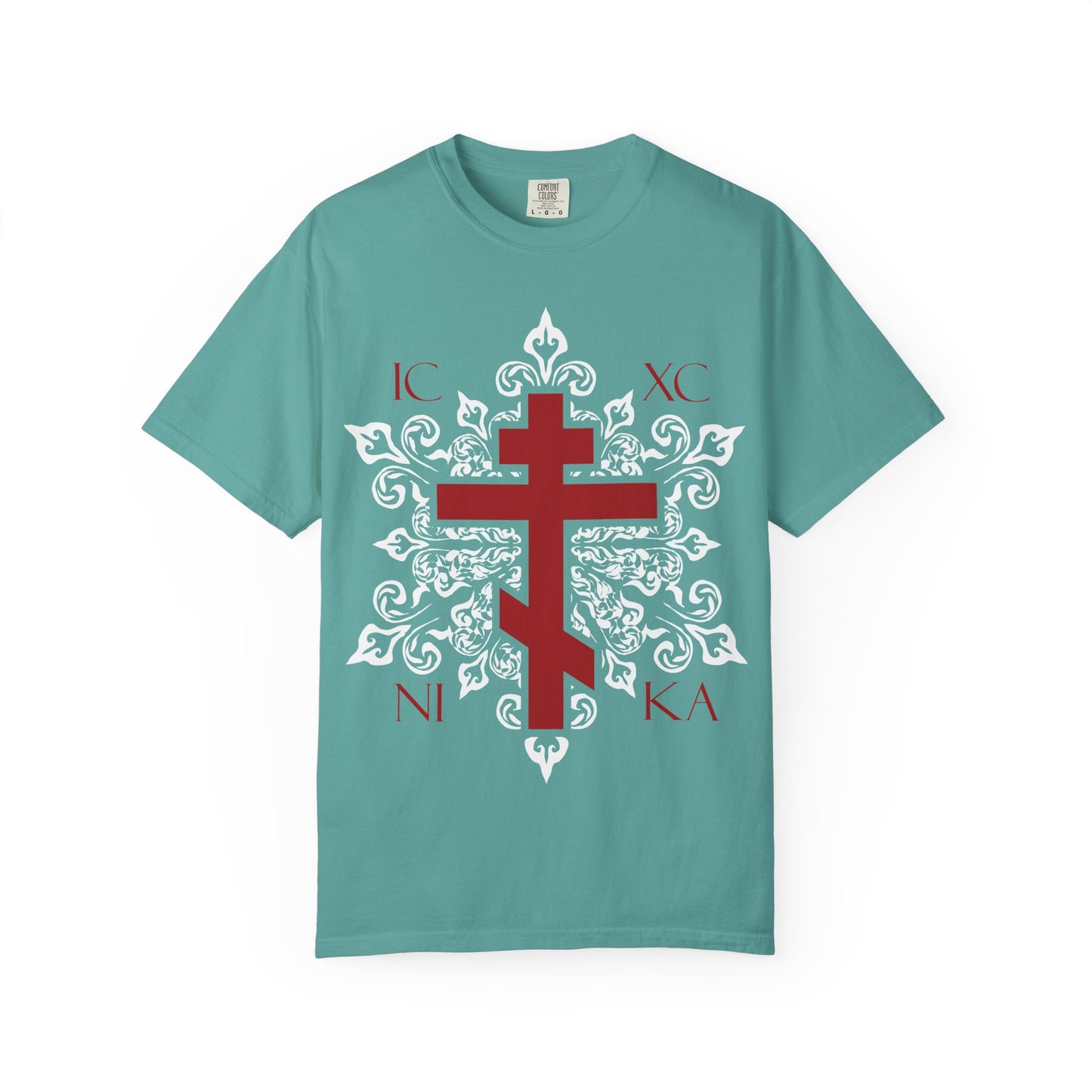 Seafoam heavyweight cotton unisex tee featuring a red ICXC / NIKA Orthodox cross set within an ornate white medieval floral design, inspired by the Adoration at the Cross and themes from the Paradise as described in the Kontakia of St. Romanos.