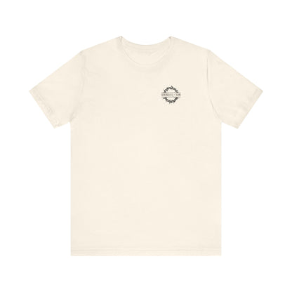 Natural lightweight cotton unisex tee with a branded front and subtle graphic, inspired by the Ladder of Divine Ascent and dispassion, featuring “Dead to this World”—Christian goth flower cross & skull design.