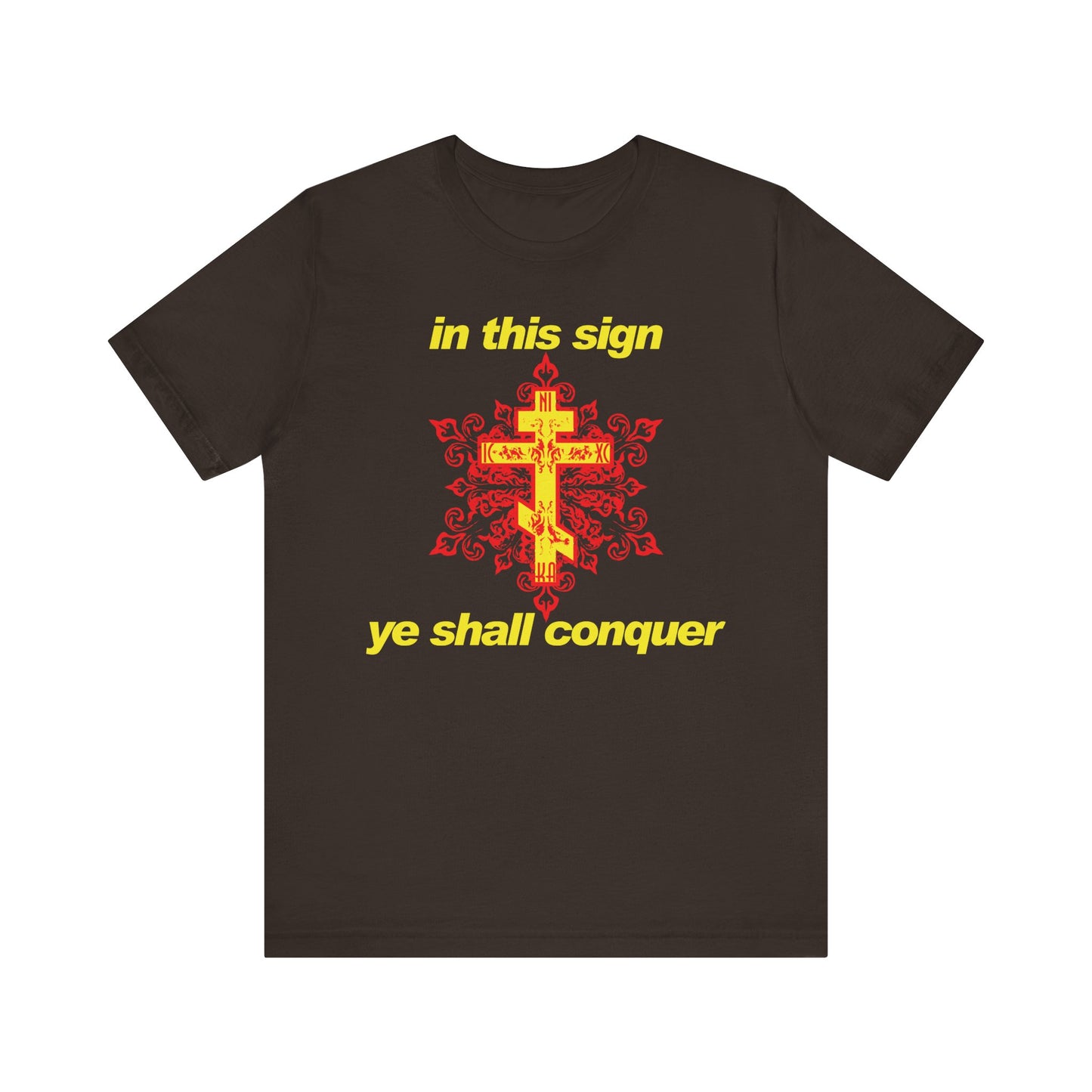 Brown t-shirt featuring a red and yellow modern design with bold yellow text reading “In This Sign Ye Shall Conquer”—inspired by the spiritual guidance of St Theophan the Recluse, this Orthodox Christian lightweight cotton unisex tee is a striking reminder for those seeking prayer against temptation.