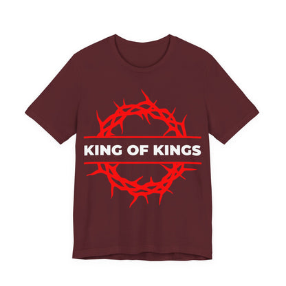 Maroon cotton unisex tee featuring a red crown of thorns and “KING OF KINGS” in bold white, inspired by Revelation 19:16. King of Kings Crown of Thorns design—Orthodox Christian apparel.